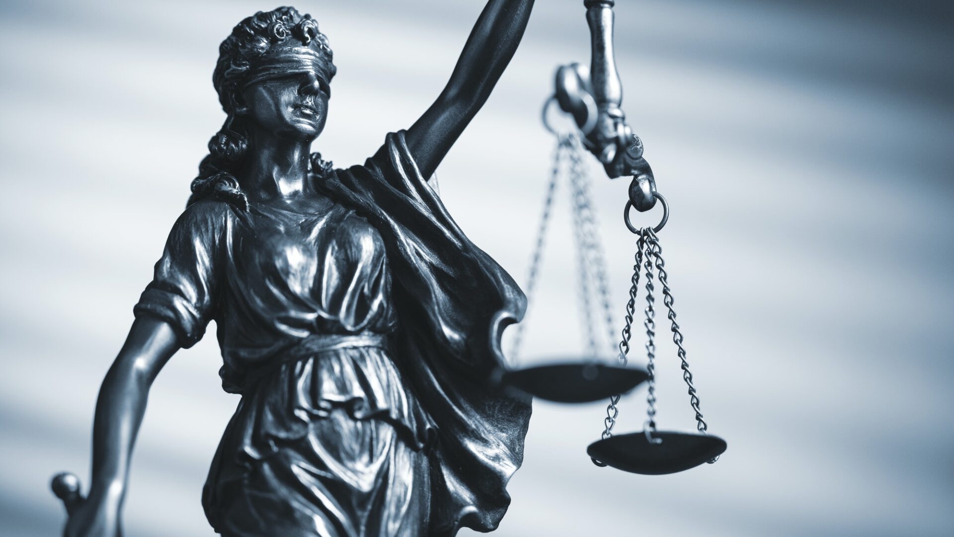 Figure of Justice holding scales and a sword